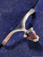 Front view of silver ring showing pear-cut garnet