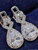 Front view of earrings showing teardrop CZ and pavé halo