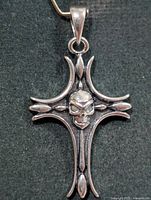 Front view of silver skull cross pendant