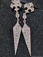 Front view of both earrings showing CZ paved drop and clover stud