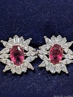 front view of both earrings showing ruby centres and CZ halos