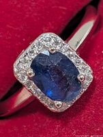 Front view of ring showing sapphire and CZ halo