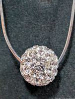 Close-up of pavé crystal bead pendant on silver chain