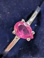 Close-up of ruby in setting on silver band