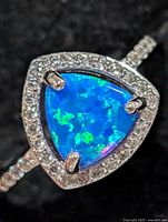 Close-up of triangular opalite and surrounding CZ halo on ring