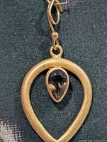 Front view showing teardrop frame and smoky quartz
