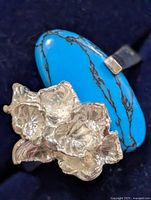 Front view showing turquoise cabochon and silver floral accent