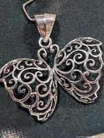 Front view of silver filigree butterfly pendant