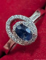 Front view showing oval sapphire and CZ halo
