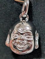 Front view of silver laughing Buddha head pendant