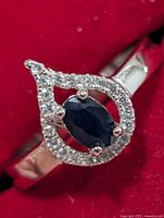front view of ring showing sapphire and CZ halo design