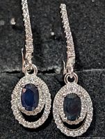 front view showing sapphire centres, CZ halos and CZ-lined ear wires
