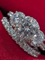 Front view of stacked engagement ring and band highlighting center moissanite and CZ stones