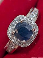 Front view of ring showing sapphire center and CZ halo