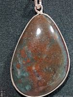 Front view of teardrop bloodstone pendant in silver bezel