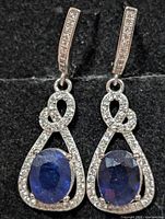 Full view of both earrings showing design and stones