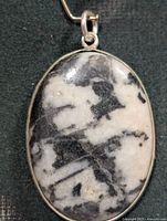 Front view of oval pinolite jasper pendant in silver bezel