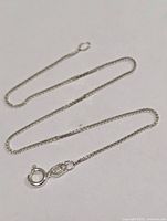 Full view of silver anklet bracelet laid flat