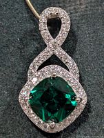 Front view of silver pendant showing chrome diopside center and CZ halo