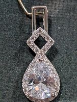 Front view showing pear CZ, halo, square link, bail