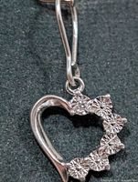 Front view of silver heart pendant showing diamond arrangement