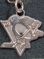 Front view of silver Pittsburgh Penguins logo pendant