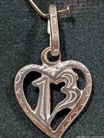 Front view of heart pendant showing cut-out 13 and swirl design