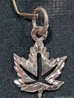 full view of silver maple leaf pendant, jump ring visible