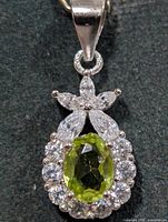 Front view showing peridot center and CZ halo