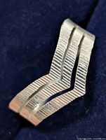 Oblique view highlighting ridged texture and double chevron design