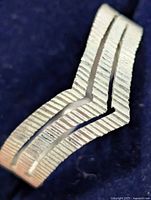 Close-up of ridged chevron detail on ring