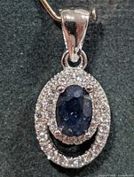 Front view of silver sapphire and CZ pendant