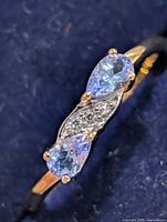 Top view showing two pear-cut tanzanites and central accent stones