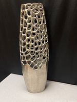 Full view of metallic silver cut-out vase, front side