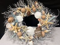 Front view of silvery seashell wreath, full form visible