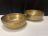 Two brass bowls side by side