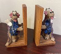 Front view of both ceramic dragon bookends showing design and wooden bases