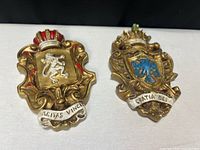 Both heraldic wall plaques side by side