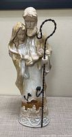 Full front view of ceramic Holy Family nativity statue with metal staff