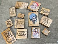 All 13 wood-mounted rubber stamps laid out on fabric surface