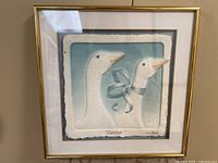 Full view of framed WESS cast paper artwork showing geese image, matting and gold frame