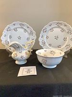Group shot of two plates, bowl, creamer showing pattern and condition