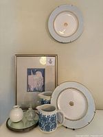 Group shot showing pitchers, plates, framed print, mirror, vase, perfume bottle