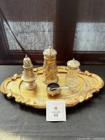 Entire lot on tray showing three casters, salt cellar with spoon, wooden tray