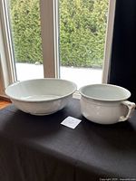 Serving bowl and chamber pot side by side on table
