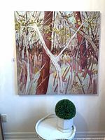 Full view of square Sue Tupy forest painting hung on wall