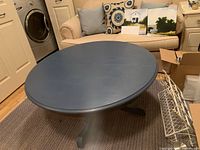 Full view of blue round coffee table in room setting