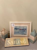 All items: two wooden buoys, plank sign reading Sailing, framed sailboat print