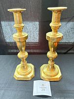 Full view of both brass candlesticks on display