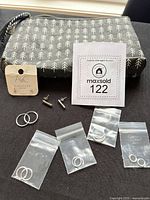 All contents: five bagged hoop earring pairs, two stud earring pairs, patterned cosmetic bag
